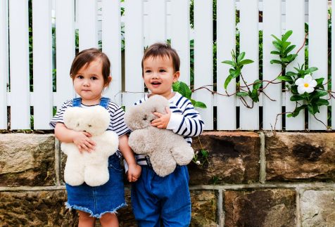 kids cuddling with a teddy bear