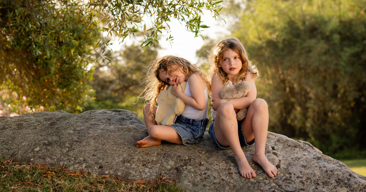 Child holding FLATOUTbear soft toys